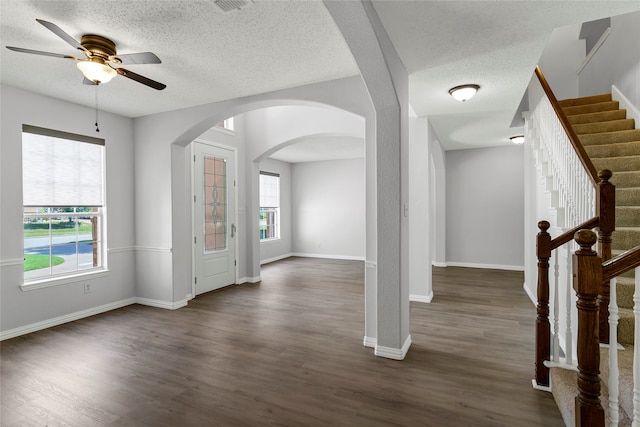 interior space with ceiling fan, hardwood / wood-style flooring, a textured ceiling, and a wealth of natural light