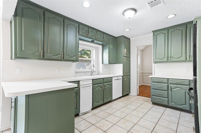 kitchen featuring light tile patterned flooring, sink, a textured ceiling, and white dishwasher