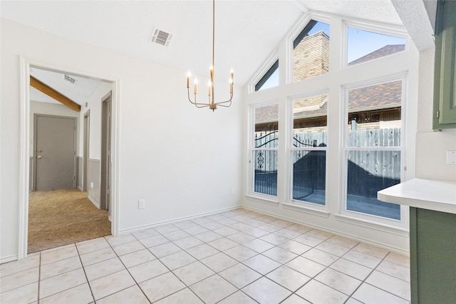 unfurnished dining area featuring an inviting chandelier, lofted ceiling with beams, and light tile patterned flooring