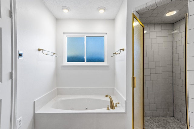 bathroom with independent shower and bath and a textured ceiling