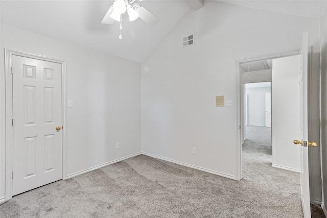 empty room featuring high vaulted ceiling, beamed ceiling, light colored carpet, and ceiling fan