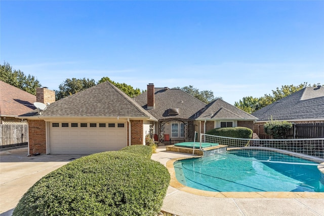 view of swimming pool featuring an in ground hot tub and a patio