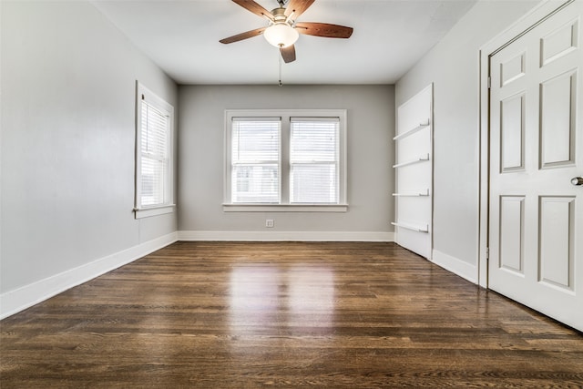 spare room featuring ceiling fan and dark wood-type flooring