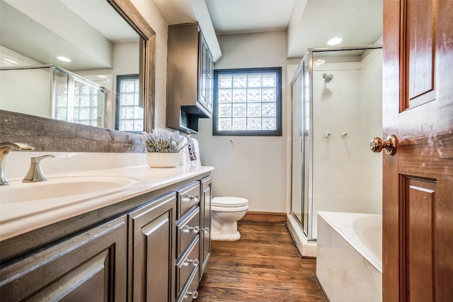 full bathroom featuring separate shower and tub, hardwood / wood-style floors, vanity, and toilet