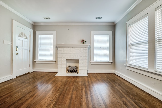 unfurnished living room featuring crown molding, dark hardwood / wood-style flooring, and a fireplace