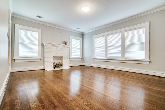 unfurnished living room featuring hardwood / wood-style floors, ornamental molding, and a fireplace