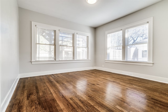 spare room with dark hardwood / wood-style floors