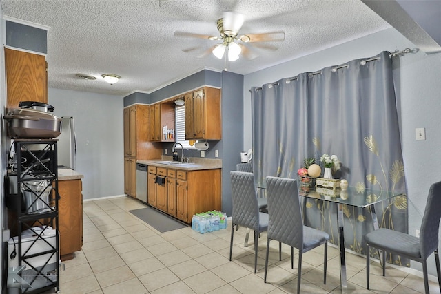 kitchen with sink, light tile patterned floors, ceiling fan, stainless steel appliances, and a textured ceiling