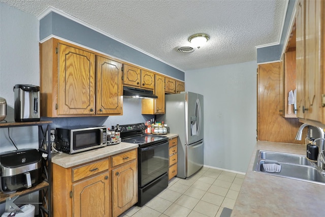 kitchen with stainless steel appliances, sink, a textured ceiling, and light tile patterned floors