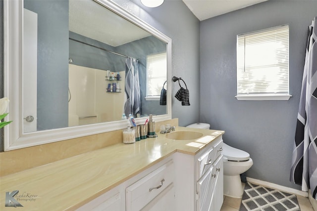 bathroom featuring vanity, curtained shower, tile patterned floors, and toilet