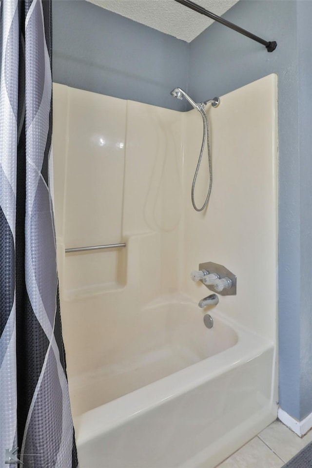 bathroom featuring shower / bath combo, tile patterned floors, and a textured ceiling