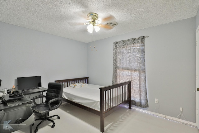 bedroom with a textured ceiling and ceiling fan