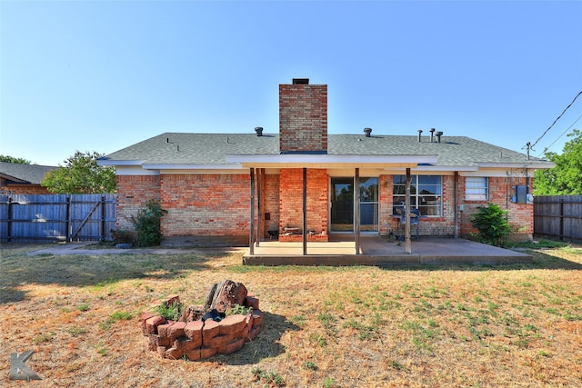 back of house with a yard and a patio