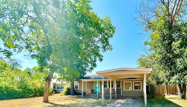 rear view of property featuring a porch