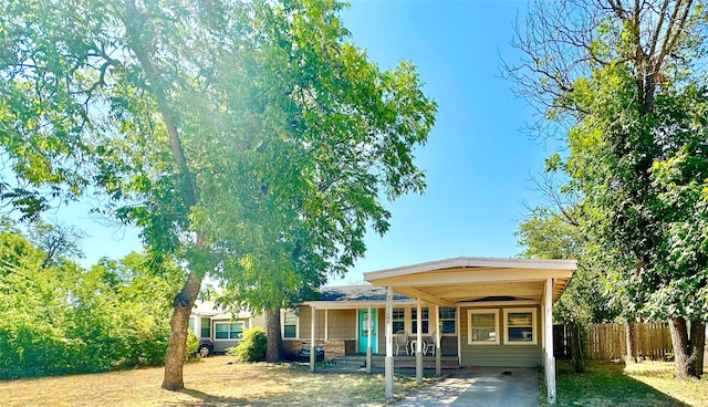 view of front of property with fence and a carport