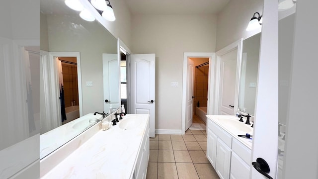 bathroom with tile patterned floors, vanity, and tiled shower / bath combo