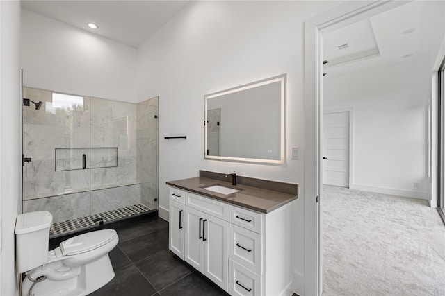 bathroom with a tile shower, vanity, tile patterned flooring, and toilet