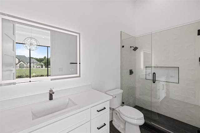 bathroom featuring a notable chandelier, walk in shower, toilet, and vanity