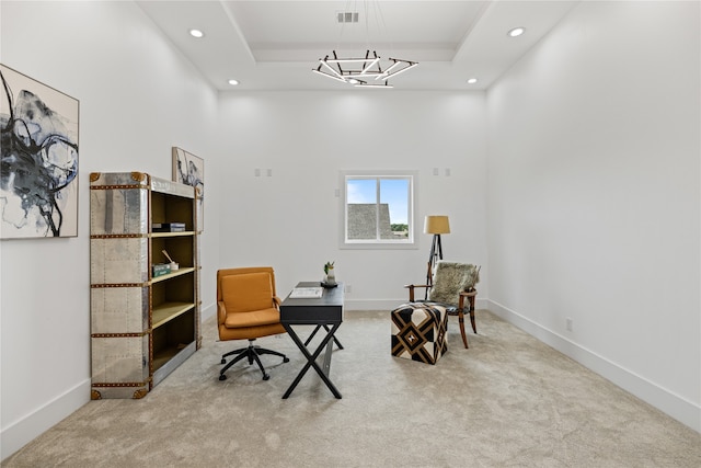 interior space featuring a towering ceiling, a notable chandelier, and a tray ceiling