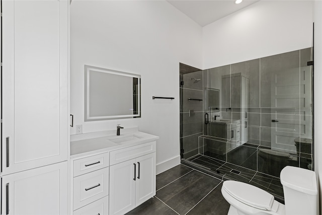 bathroom featuring a shower with shower door, vanity, tile patterned floors, and toilet