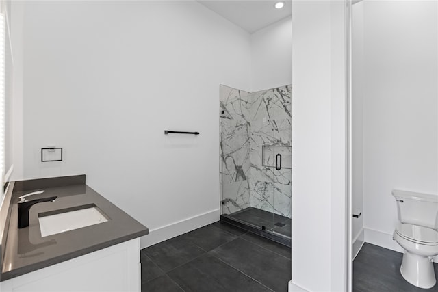 bathroom featuring a shower with shower door, vanity, tile patterned floors, and toilet