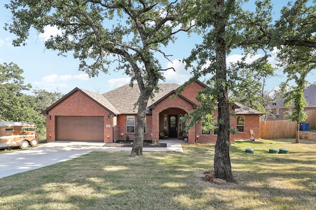 view of front of property featuring a garage and a front lawn