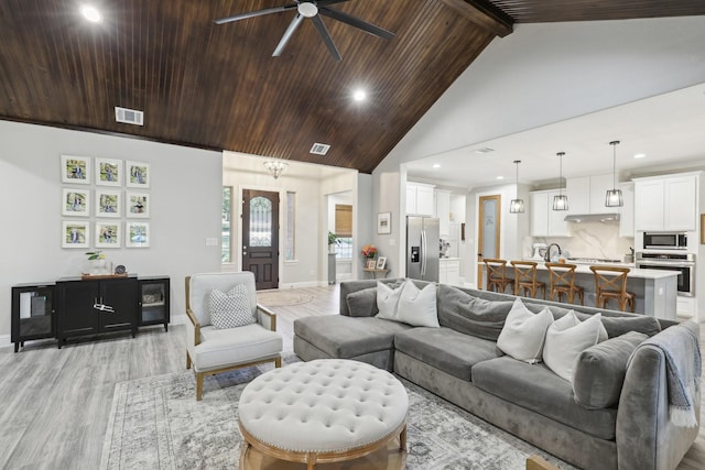 living room with ceiling fan, beam ceiling, high vaulted ceiling, wooden ceiling, and light hardwood / wood-style floors