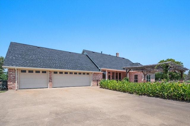 view of front of house with a garage, brick siding, driveway, and a shingled roof