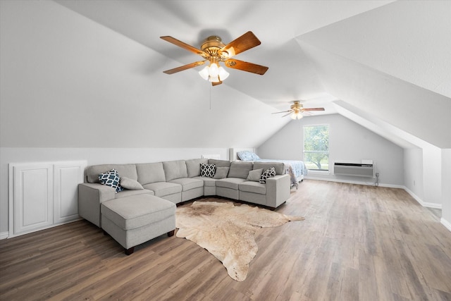 living room featuring lofted ceiling, baseboards, wood finished floors, and an AC wall unit