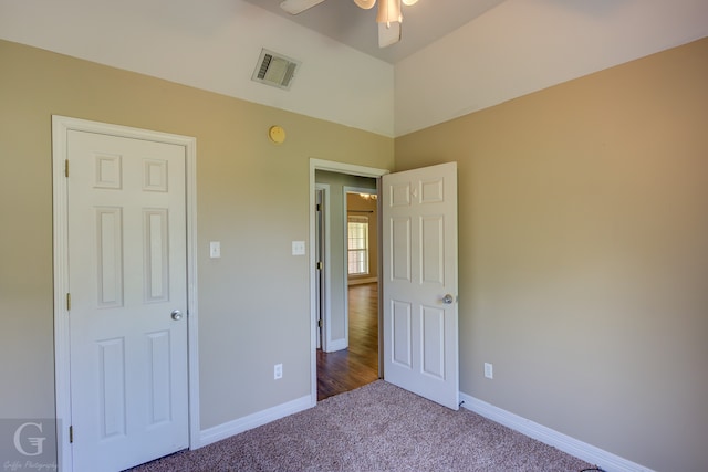 unfurnished bedroom featuring ceiling fan and carpet