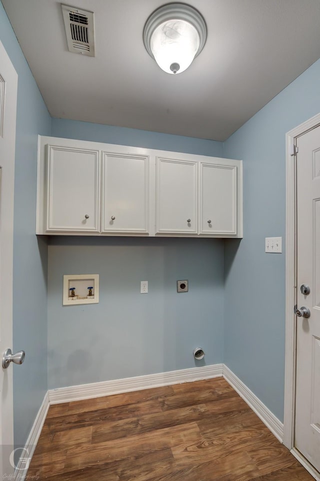 laundry room featuring hookup for a washing machine, hookup for an electric dryer, visible vents, cabinet space, and dark wood-style floors