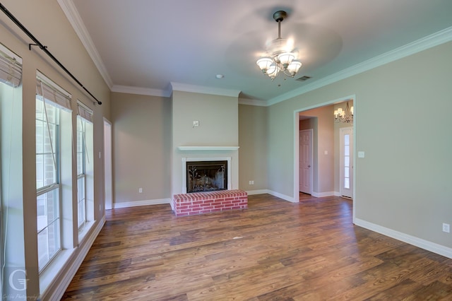 unfurnished living room with a chandelier, a brick fireplace, dark wood finished floors, and baseboards