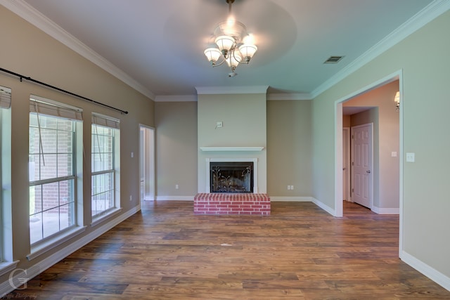 unfurnished living room featuring a brick fireplace, crown molding, hardwood / wood-style floors, and ceiling fan