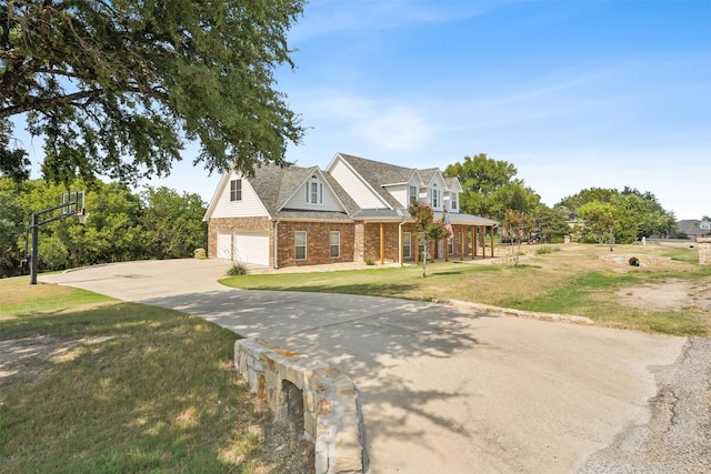 cape cod house with a front lawn and a garage