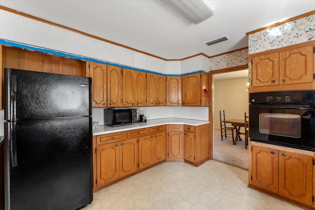 kitchen featuring black appliances and ornamental molding