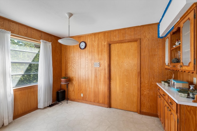 dining room with wood walls