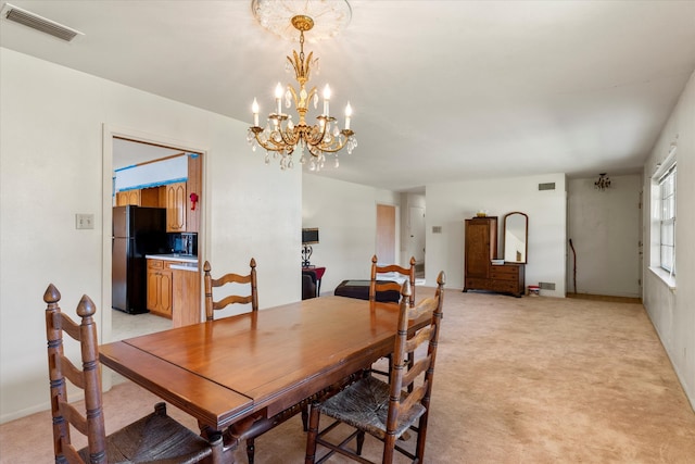 dining area with a chandelier and light colored carpet