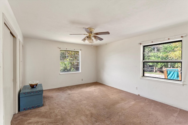 unfurnished bedroom featuring carpet flooring, ceiling fan, and a closet