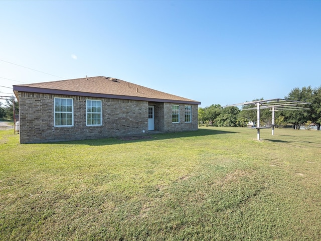 rear view of property with a pergola and a yard