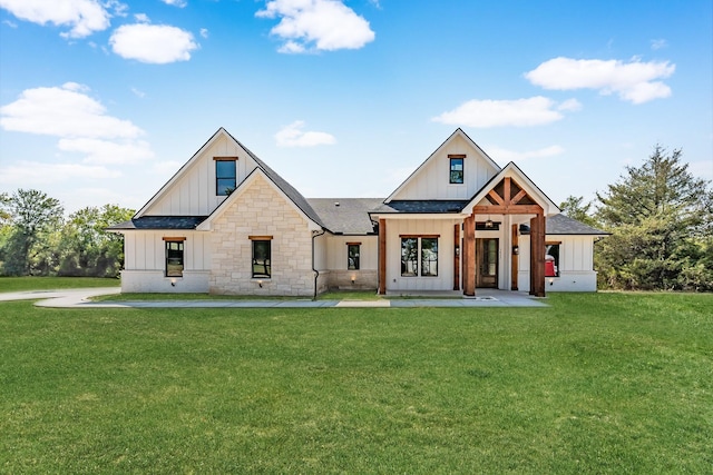 modern farmhouse style home featuring a front lawn, board and batten siding, and a shingled roof