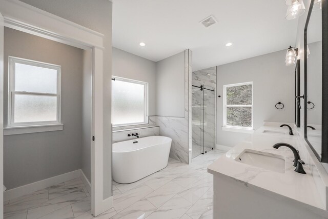 bathroom featuring dual bowl vanity, plus walk in shower, and tile patterned flooring