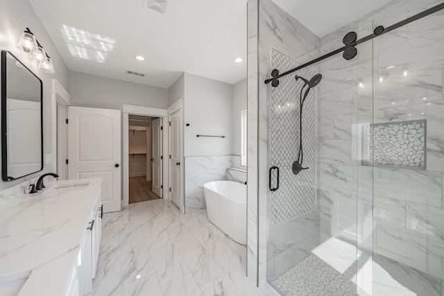 bathroom featuring a stall shower, a freestanding tub, visible vents, and marble finish floor