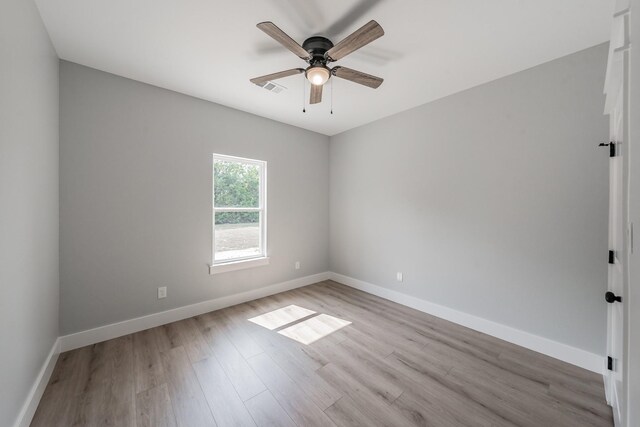 empty room featuring ceiling fan and light wood-type flooring