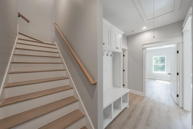 mudroom featuring recessed lighting, light wood-type flooring, attic access, and baseboards