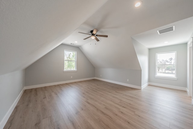 additional living space with ceiling fan, lofted ceiling, and light hardwood / wood-style floors