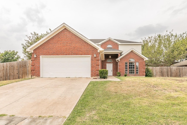 traditional home featuring driveway, a garage, fence, a front lawn, and brick siding