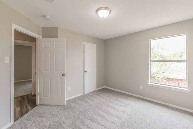 unfurnished bedroom with carpet and a closet