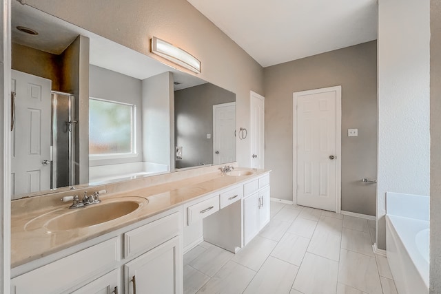 bathroom featuring tile patterned floors, double vanity, and plus walk in shower