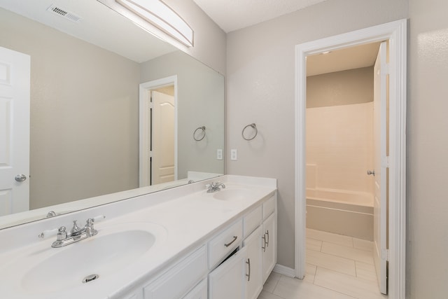 bathroom with shower / bathtub combination, double vanity, and tile patterned flooring