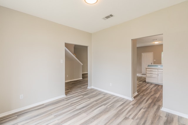 empty room with light hardwood / wood-style flooring